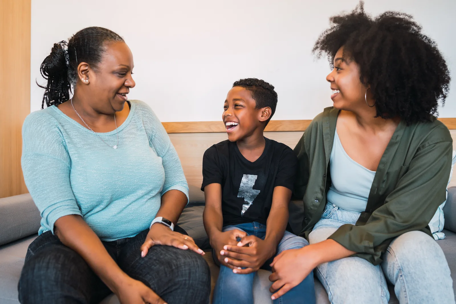 A grandmother, mother, and child spending time together at home