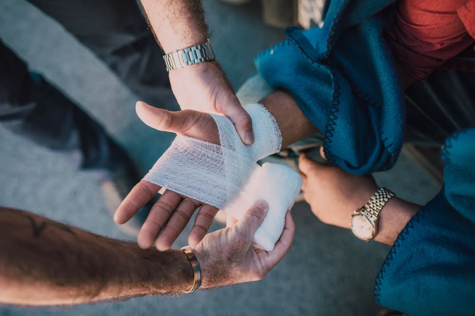 A person practicing how to wrap a hand bandage