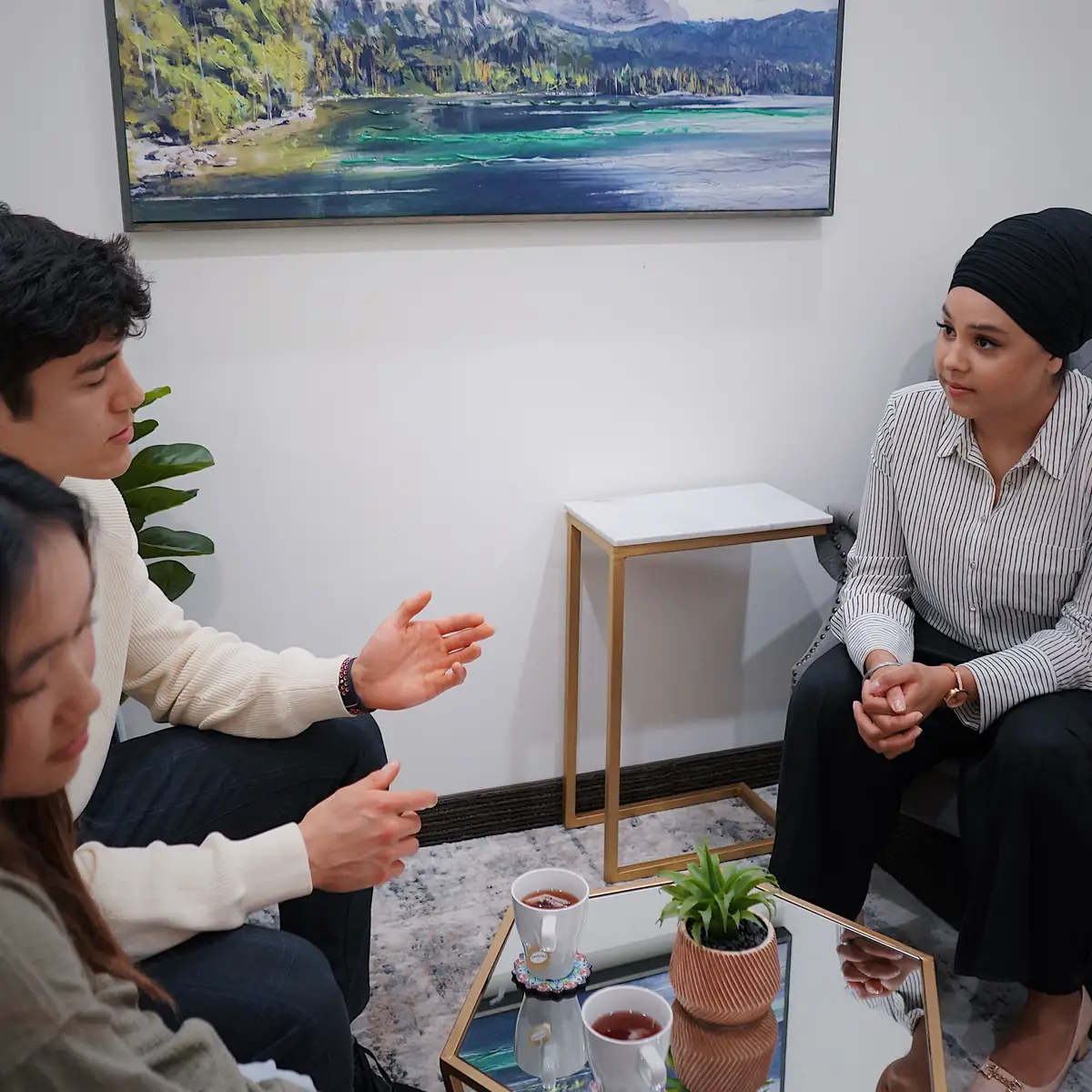 Adults from different backgrounds seated in a group conversation
